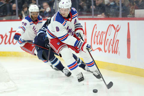 Mar 6, 2022; Winnipeg, Manitoba, CAN; New York Rangers defenseman Jacob Trouba (8) skates away from Winnipeg Jets forward Jansen Harkins (12) during the second period at Canada Life Centre. Mandatory Credit: Terrence Lee-USA TODAY Sports