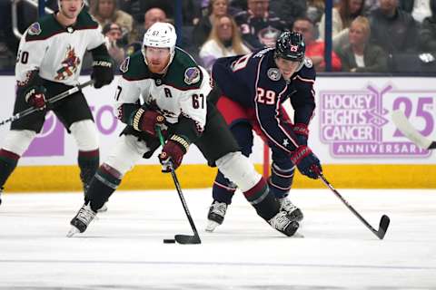 COLUMBUS, OHIO – NOVEMBER 16: Lawson Crouse #67 of the Arizona Coyotes battles Patrik Laine #29 of the Columbus Blue Jackets for the puck during the first period at Nationwide Arena on November 16, 2023 in Columbus, Ohio. (Photo by Jason Mowry/Getty Images)