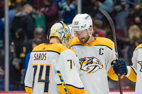 Nov 5, 2021; Vancouver, British Columbia, CAN; Nashville Predators defenseman Roman Josi (59) and goalie Juuse Saros (74) celebrate their victory over the Vancouver Canucks in the third period at Rogers Arena. Predators won 3-2. Mandatory Credit: Bob Frid-USA TODAY Sports