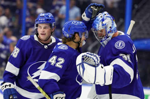 Sep 29, 2023; Tampa, Florida, USA; Tampa Bay Lightning goaltender Jonas Johansson (31) is congratulated by Tampa Bay Lightning center Felix Robert (42) and defenseman Jack Thompson (28) after beating the Carolina Hurricanes during preseason at Amalie Arena. Mandatory Credit: Nathan Ray Seebeck-USA TODAY Sports