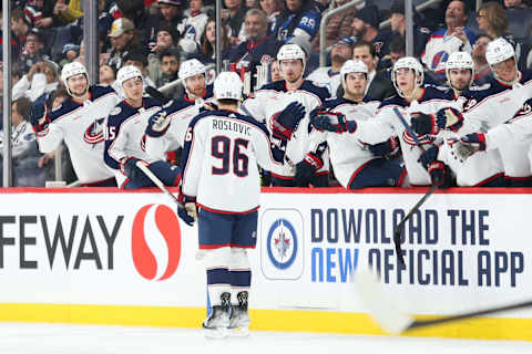 Dec 2, 2022; Winnipeg, Manitoba, CAN; Columbus Blue Jackets forward Jack Roslovic (96) is congratulated by his team mates on his goal against the Winnipeg Jets during the first period at Canada Life Centre. Mandatory Credit: Terrence Lee-USA TODAY Sports