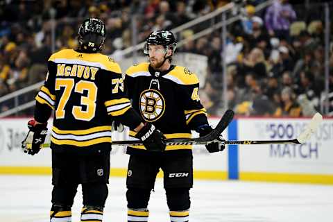 PITTSBURGH, PENNSYLVANIA – APRIL 21: Charlie McAvoy #73 and Matt Grzelcyk #48 of the Boston Bruins talk during a game between the Pittsburgh Penguins and Boston Bruins at PPG PAINTS Arena on April 21, 2022 in Pittsburgh, Pennsylvania. (Photo by Emilee Chinn/Getty Images)