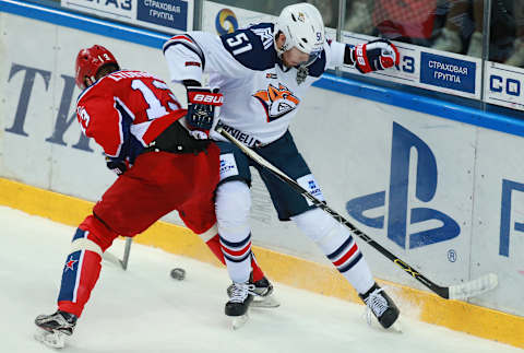 MOSCOW, RUSSIA. APRIL 9, 2016. CSKA’s Roman Lyubimov (L) and Metallurg’s Alexei Bereglazov fight for the puck in the second match of the 2015/2016 Season Kontinental Hockey League finals at CSKA Stadium. Sergei Fadeichev/TASS (Photo by Sergei FadeichevTASS via Getty Images)