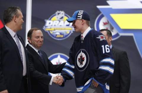 Jun 24, 2016; Buffalo, NY, USA; Patrik Laine shakes hands with NHL commissioner Gary Bettman after being selected as the number two overall draft pick by the Winnipeg Jets in the first round of the 2016 NHL Draft at the First Niagra Center. Mandatory Credit: Timothy T. Ludwig-USA TODAY Sports