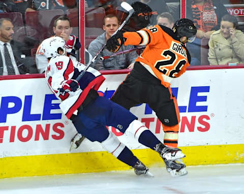 Mar 30, 2016; Philadelphia, PA, USA; Washington Capitals center Nicklas Backstrom (19) checks Philadelphia Flyers center Claude Giroux (28) during the third period at Wells Fargo Center. The Flyers defeated the Capitals, 2-1 in a shootout. Mandatory Credit: Eric Hartline-USA TODAY Sports