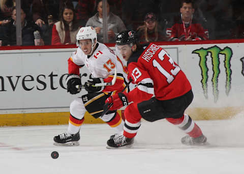 Nico Hischier #13 of the New Jersey Devils and Johnny Gaudreau #13 of the Calgary Flames (Photo by Bruce Bennett/Getty Images)