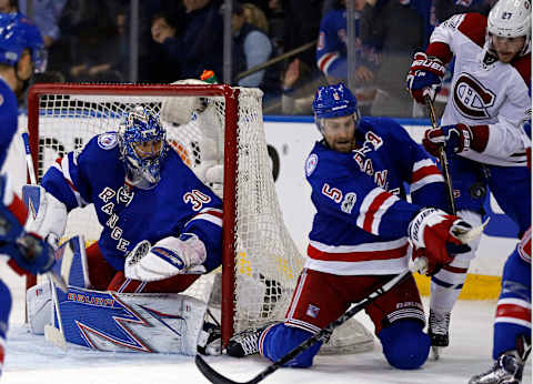 Apr 18, 2017; New York, NY, USA; New York Rangers goalie Henrik Lundqvist (30) looks on as Rangers defenseman Dan Girardi (5) knocks the puck away from Montreal Canadiens center Alex Galchenyuk (27) during the third period in game four of the first round of the 2017 Stanley Cup Playoffs at Madison Square Garden. Mandatory Credit: Adam Hunger-USA TODAY Sports