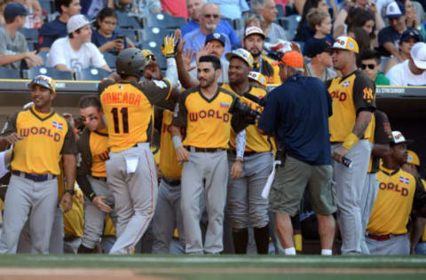 Jul 10, 2016; San Diego, CA, USA; World infielder Yoan Moncada (11) celebrates with teammates after a two-run home run during the All Star Game futures baseball game at PetCo Park. Mandatory Credit: Jake Roth-USA TODAY Sports