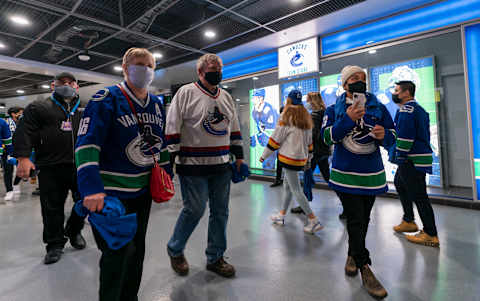 VANCOUVER, BC – OCTOBER 26: Hockey fans walk past the team store prior to NHL action between the Vancouver Canucks and Minnesota Wild on October, 26, 2021 at Rogers Arena in Vancouver, British Columbia, Canada. (Photo by Rich Lam/Getty Images)