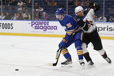 BUFFALO, NEW YORK – OCTOBER 16: Anton Stralman #86 of the Arizona Coyotes (R) and Anders Bjork #96 of the Buffalo Sabres battle for the puck during the first period at KeyBank Center on October 16, 2021 in Buffalo, New York. (Photo by Joshua Bessex/Getty Images)