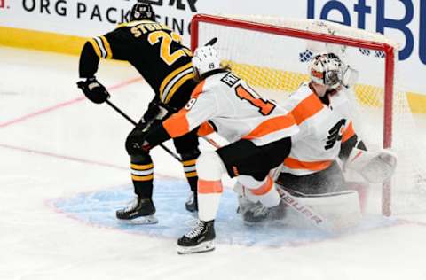 Jan 21, 2021; Boston, Massachusetts, USA; Boston Bruins center Jack Studnicka (23) scores on Philadelphia Flyers goaltender Carter Hart (79) during the third period at the TD Garden. Mandatory Credit: Brian Fluharty-USA TODAY Sports