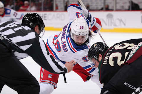 GLENDALE, ARIZONA – DECEMBER 15: Mika Zibanejad #93 of the New York Rangers faces off against Barrett Hayton #29 of the Arizona Coyotes during the third period of the NHL game at Gila River Arena on December 15, 2021 in Glendale, Arizona. The Rangers defeated the Coyotes 3-2. (Photo by Christian Petersen/Getty Images)