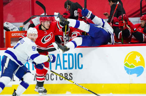 Feb 22, 2021; Raleigh, North Carolina, USA; Carolina Hurricanes right wing Jesper Fast (71) checks Tampa Bay Lightning defenseman Erik Cernak (81) during the second period at PNC Arena. Mandatory Credit: James Guillory-USA TODAY Sports