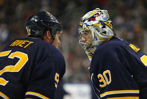 Dec 21, 2010; Buffalo, NY, USA; Buffalo Sabres goalie Ryan Miller (30) and defenseman Craig Rivet (52) talk during a time out in the third period against the Anaheim Ducks at HSBC Arena. Buffalo defeats Anaheim 5-2. Mandatory Credit: Timothy T. Ludwig-USA TODAY Sports