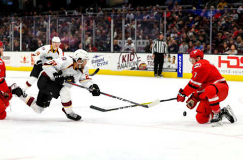 CLEVELAND, OH – NOVEMBER 03: Charlotte Checkers ldefenceman Chase Priskie (7) blocks the shot of Cleveland Monsters center Justin Scott (20) during the second period of the American Hockey League game between the Charlotte Checkers and Cleveland Monsters on November 3, 2019, at Rocket Mortgage FieldHouse in Cleveland, OH.(Photo by Frank Jansky/Icon Sportswire via Getty Images)