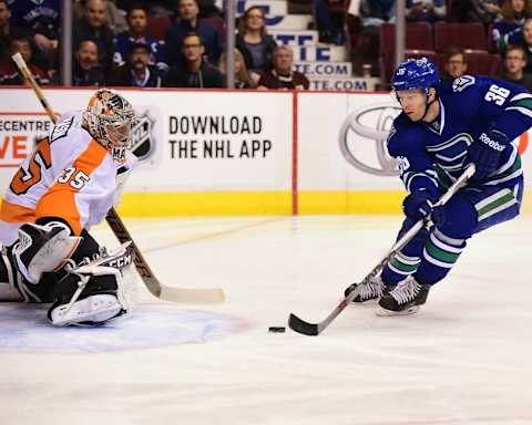 Nov 2, 2015; Vancouver, British Columbia, CAN; Vancouver Canucks forward Jannik Hansen (36) moves the puck against Philadelphia Flyers goaltender Steve Mason (35) during the first period at Rogers Arena. Mandatory Credit: Anne-Marie Sorvin-USA TODAY Sports