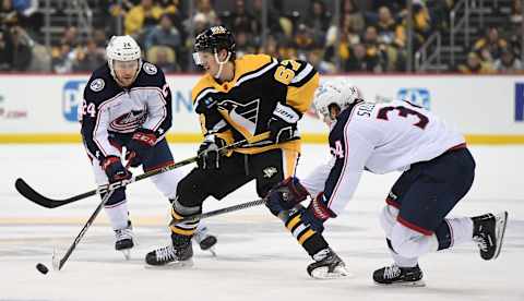 PITTSBURGH, PA – DECEMBER 06: Rickard Rakell #67 of the Pittsburgh Penguins skates with the puck as Cole Sillinger #34 of the Columbus Blue Jackets defends in the third period during the game at PPG PAINTS Arena on December 6, 2022 in Pittsburgh, Pennsylvania. (Photo by Justin Berl/Getty Images)