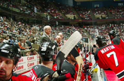 EAST RUTHERFORD, NJ – MAY 10: Assistant coach Jacques Laperriere of the New Jersey Devils watches from the bench against the Carolina Hurricanes in game three of the Eastern Conference Semifinals during the 2006 NHL Playoffs on May 10, 2006 at Continental Airlines Arena in East Rutherford, New Jersey. The Hurricanes defeated the Devils 3-2. (Photo by Bruce Bennett/Getty Images)