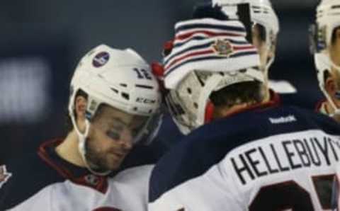 Jets right wing Drew Stafford (12) greets goalie Connor Hellebuyck (37) after the third period at the 2016 Heritage Classic ice hockey game at Investors Group Field ( Bruce Fedyck-USA TODAY Sports )