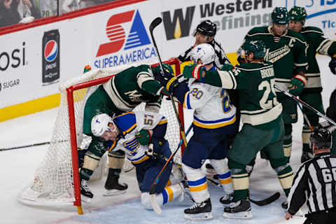 Apr 22, 2017; Saint Paul, MN, USA; St Louis Blues forward David Perron (57) pushes Minnesota Wild defenseman Ryan Suter (20) into the net in the third period in game five of the first round of the 2017 Stanley Cup Playoffs at Xcel Energy Center. Mandatory Credit: Brad Rempel-USA TODAY Sports