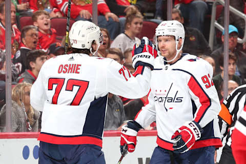 CHICAGO, IL – OCTOBER 20: T.J. Oshie #77 and Evgeny Kuznetsov #92 of the Washington Capitals celebrate in the first period after scoring against the Chicago Blackhawks at the United Center on October 20, 2019 in Chicago, Illinois. (Photo by Chase Agnello-Dean/NHLI via Getty Images)