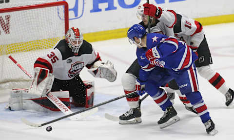 Rochester’s Brandon Biro (10) spins and tries to knock the puck past Utica goalie Nico Daws in the first period during Game 4 of their North Division semifinal series Tuesday, May 17, 2022 at Blue Cross Arena. Utica won the game 4-2.Sd 051722 Amerks K Spts