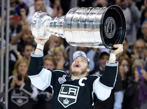 Jun 13, 2014; Los Angeles, CA, USA; Los Angeles Kings right wing Dustin Brown hoists the Stanley Cup after defeating the New York Rangers in game five of the 2014 Stanley Cup Final at Staples Center. Mandatory Credit: Gary A. Vasquez-USA TODAY Sports