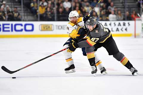 LAS VEGAS, NEVADA – OCTOBER 15: Shea Theodore #27 of the Vegas Golden Knights battles Ryan Ellis #4 of the Nashville Predators during the second period at T-Mobile Arena on October 15, 2019 in Las Vegas, Nevada. (Photo by Jeff Bottari/NHLI via Getty Images)