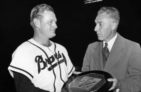 (Original Caption) Honor Braves’ Third Baseman: Braves Field, Boston, Massachusetts: Voted the “most valuable player of 1947,” Bob Elliot, Braves third-sacker receives the Judge Kenesaw Mountain Landis Trophy, presented in honor of baseball’s late commissioner from Ford Frick, the National League President. Presentation preceded the Braves night game.