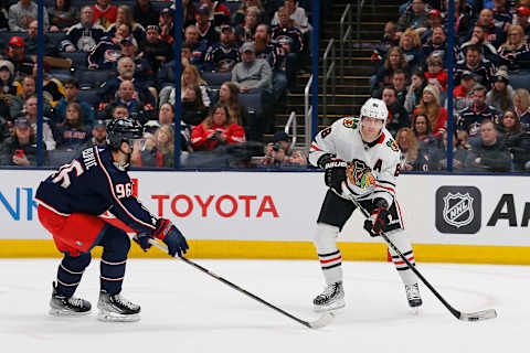 Dec 31, 2022; Columbus, Ohio, USA; Chicago Blackhawks right wing Patrick Kane (88) passes the puck as Columbus Blue Jackets center Jack Roslovic (96) defendsduring the first period at Nationwide Arena. Mandatory Credit: Russell LaBounty-USA TODAY Sports