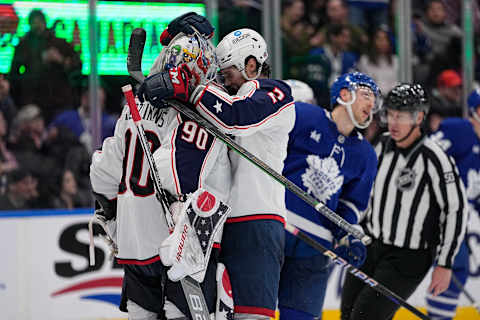 Feb 11, 2023; Toronto, Ontario, CAN; Columbus Blue Jackets defenseman Andrew Peeke (2) and goaltender Elvis Merzlikins (90) celebrate a win over the Toronto Maple Leafs during the third period at Scotiabank Arena. Mandatory Credit: John E. Sokolowski-USA TODAY Sports