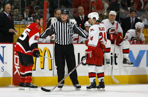 OTTAWA, CANADA – FEBRUARY 28: Linesman Lonnie Cameron gets in between Chris Neil #25 of the Ottawa Senators and Scott Walker #24 of the Carolina Hurricanes during a game on February 28, 2007 at the Scotiabank Place in Ottawa, Canada. The Ottawa Senators defeated the Carolina Hurricanes 2-0. (Photo by Phillip MacCallum/Getty Images)