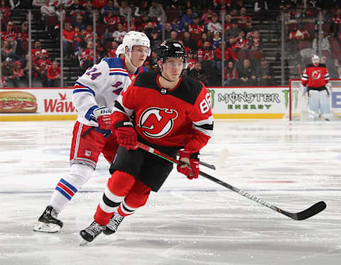 Kaapo Kakko #24 of the New York Rangers skates against Jack Hughes #86 of the New Jersey Devils. (Photo by Bruce Bennett/Getty Images)