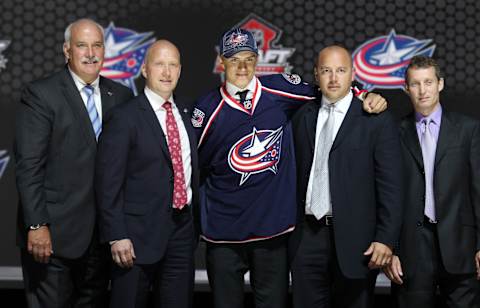 Jun 30, 2013; Newark, NJ, USA; Alexander Wennberg poses for a photo with team officials after being introduced as the number fourteen overall pick to the Columbus Blue Jackets during the 2013 NHL Draft at the Prudential Center. Mandatory Credit: Ed Mulholland-USA TODAY Sports