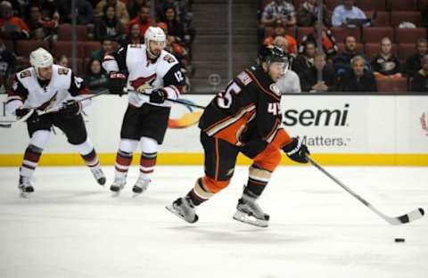 November 9, 2015; Anaheim, CA, USA; Anaheim Ducks defenseman Sami Vatanen (45) moves the puck against Arizona Coyotes center Brad Richardson (12) and center Kyle Chipchura (24) during the first period at Honda Center. Mandatory Credit: Gary A. Vasquez-USA TODAY Sports