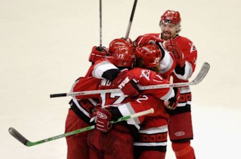 RALEIGH, NC – JUNE 05: Justin Williams #11 (R) of the Carolina Hurricanes celebrates with teammates after Rod Brind’Amour #17 scored the game-winning goal against the Edmonton Oilers during the third period of game one of the 2006 NHL Stanley Cup Finals on June 5, 2006, at the RBC Center in Raleigh, North Carolina. (Photo by Grant Halverson/Getty Images)