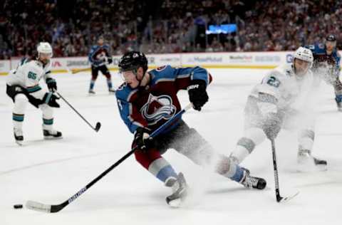 DENVER, COLORADO – MAY 06: Cale Makar #8 of the Colorado Avalanche skates the puck away from Barclay Goodrow #23 of the San Jose Sharks in the second period during Game Six of the Western Conference Second Round during the 2019 NHL Stanley Cup Playoffs at the Pepsi Center on May 6, 2019 in Denver, Colorado. (Photo by Matthew Stockman/Getty Images)