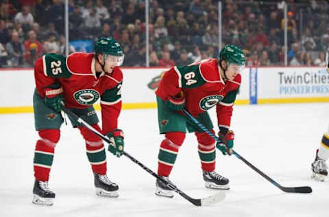 Minnesota Wild defenseman Jonas Brodin (25) and forward Mikael Granlund (64) wait for the faceoff in the first period against the Boston Bruins at Xcel Energy Center. Mandatory Credit: Brad Rempel-USA TODAY Sports