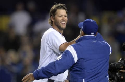 April 14, 2017; Los Angeles, CA, USA; Los Angeles Dodgers starting pitcher Clayton Kershaw (22) and manager Dave Roberts (30) celebrate the 7-1 victory against the Arizona Diamondbacks at Dodger Stadium. Mandatory Credit: Gary A. Vasquez-USA TODAY Sports