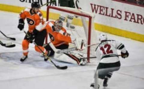 Nov 12, 2016; Philadelphia, PA, USA; Philadelphia Flyers goalie Steve Mason (35) makes a save on Minnesota Wild center Eric Staal (12) during the third period of the game at the Wells Fargo Center. The flyers won the game 3-2. Mandatory Credit: John Geliebter-USA TODAY Sports