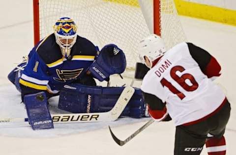 Apr 4, 2016; St. Louis, MO, USA; St. Louis Blues goalie Brian Elliott (1) defends the net against Arizona Coyotes center Max Domi (16) during the third period at Scottrade Center. The Blues won 5-2. Mandatory Credit: Jeff Curry-USA TODAY Sports