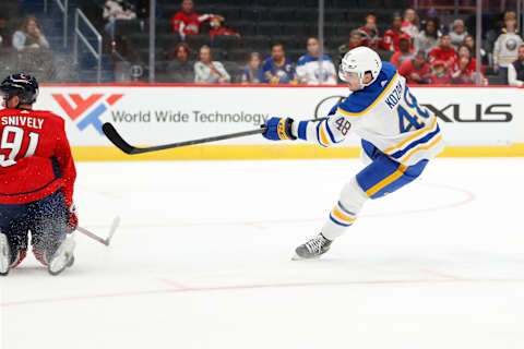 Sep 25, 2022; Washington, District of Columbia, USA; Buffalo Sabres center Tyson Kozak (48) shoots the puck to score a goal past Washington Capitals center Joe Snively (91) during the second period at Capital One Arena. Mandatory Credit: Amber Searls-USA TODAY Sports