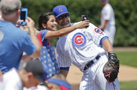 Jun 3, 2016; Chicago, IL, USA; Chicago Cubs catcher David Ross (3) poses for a picture with a fan before the MLB game against the Arizona Diamondbacks at Wrigley Field. Mandatory Credit: Kamil Krzaczynski-USA TODAY Sports