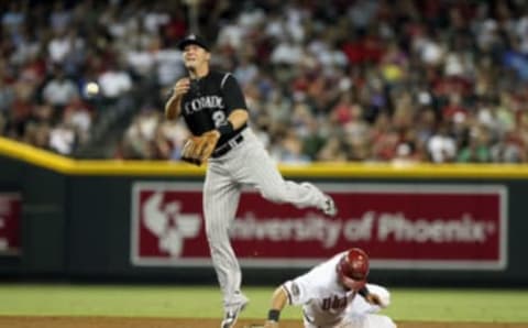 PHOENIX, AZ – JULY 22: Infielder Troy Tulowitzki #2 of the Colorado Rockies throws over the sliding Gerardo Parra #8 of the Arizona Diamondbacks attempting an unsuccessful double play during the second inning of the Major League Baseball game at Chase Field on July 22, 2011 in Phoenix, Arizona. (Photo by Christian Petersen/Getty Images)