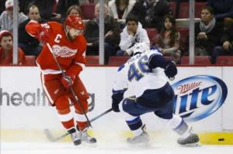 Jan 20, 2014; Detroit, MI, USA; Detroit Red Wings left wing Henrik Zetterberg (40) and St. Louis Blues defenseman Roman Polak (46) battle for the puck in the first period at Joe Louis Arena. Mandatory Credit: Rick Osentoski-USA TODAY Sports