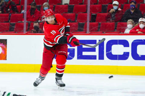 Apr 4, 2021; Raleigh, North Carolina, USA; Carolina Hurricanes defenseman Dougie Hamilton (19) takes a shot against the Dallas Stars at PNC Arena. Mandatory Credit: James Guillory-USA TODAY Sports