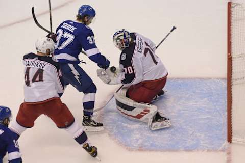 Aug 11, 2020; Toronto, Ontario, CAN; Columbus Blue Jackets goaltender Joonas Korpisalo (70) makes a save on Tampa Bay Lightning center Yanni Gourde (37) as Blue Jackets defenseman Vladislav Gavrikov (44) defends in the first overtime in game one of the first round of the 2020 Stanley Cup Playoffs at Scotiabank Arena. Mandatory Credit: Dan Hamilton-USA TODAY Sports