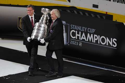 LAS VEGAS, NEVADA – JUNE 13: Craig Campbell of the Hockey Hall of Fame (L) and Keeper of the Cup for the Hockey Hall of Fame Phil Pritchard carry the Stanley Cup into the rink. (Photo by Ethan Miller/Getty Images)