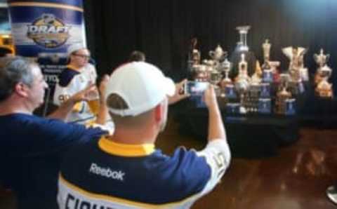 Jun 24, 2016; Buffalo, NY, USA; A general view as hockey fans take pictures of an NHL trophy and awards display before the first round of the 2016 NHL Draft at the First Niagra Center. Mandatory Credit: Jerry Lai-USA TODAY Sports