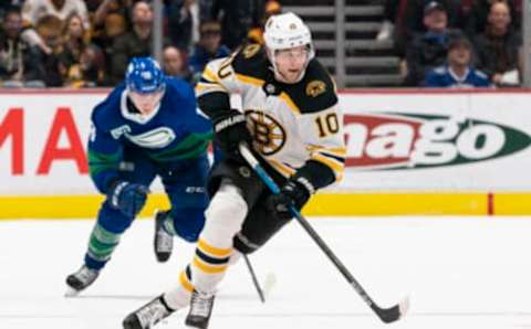 VANCOUVER, BC – FEBRUARY 22: Anders Bjork #10 of the Boston Bruins skates with the puck during NHL action against the Vancouver Canucks at Rogers Arena on February 22, 2020 in Vancouver, Canada. (Photo by Rich Lam/Getty Images)